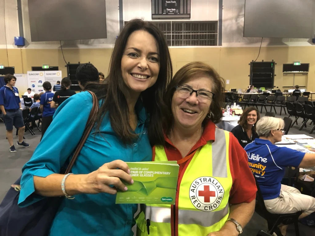 Juliette Wright standing with member a of the Red Cross